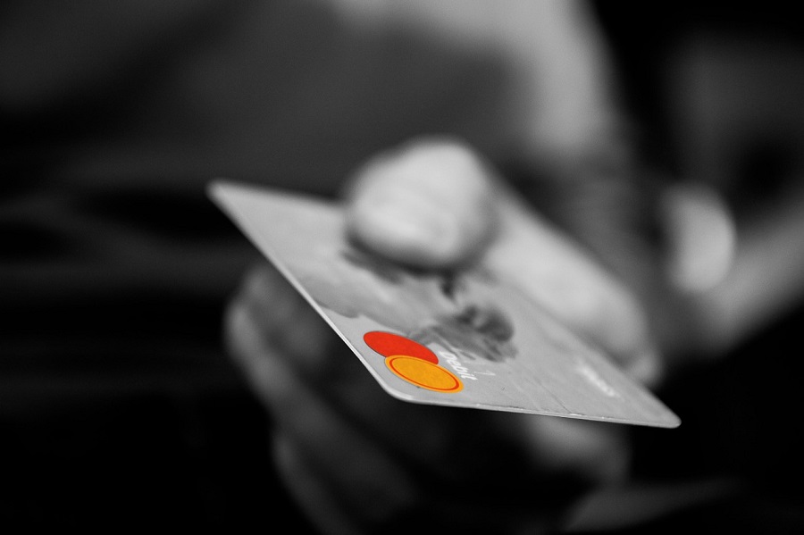 Photo of a Man Holding a Credit Card