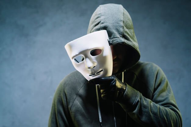 hacker-holding-mask_23-2147985363